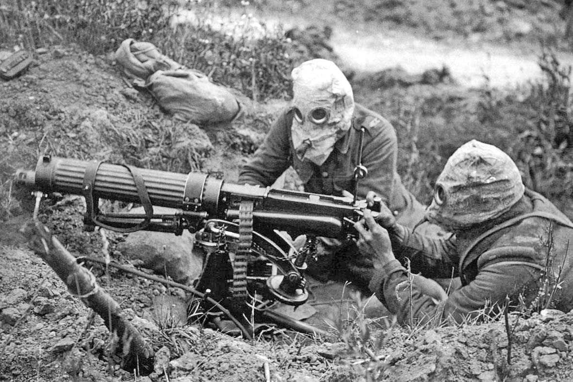 The historic photograph shows a Vickers machine gun team with anti-gas helmets.